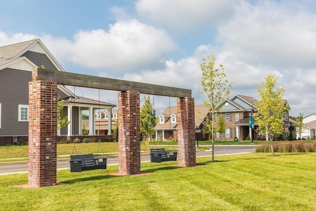 view of property's community with a lawn