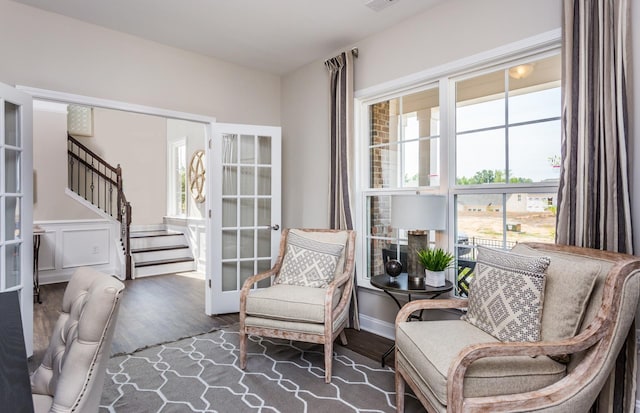 sitting room with dark hardwood / wood-style floors and french doors