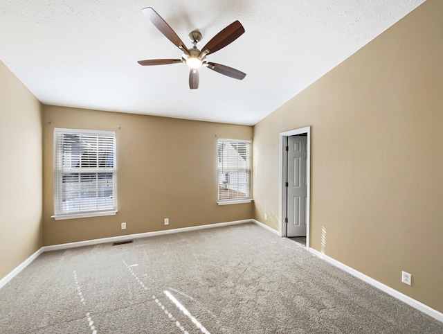 empty room with light carpet, vaulted ceiling, and ceiling fan