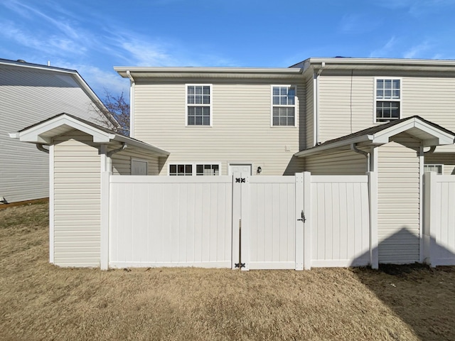 back of property featuring a lawn