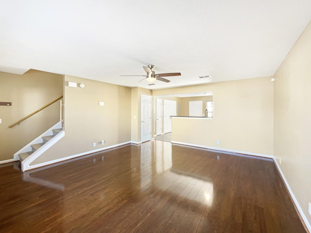 spare room with dark wood-type flooring and ceiling fan