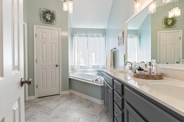 bathroom featuring a washtub, vanity, and vaulted ceiling