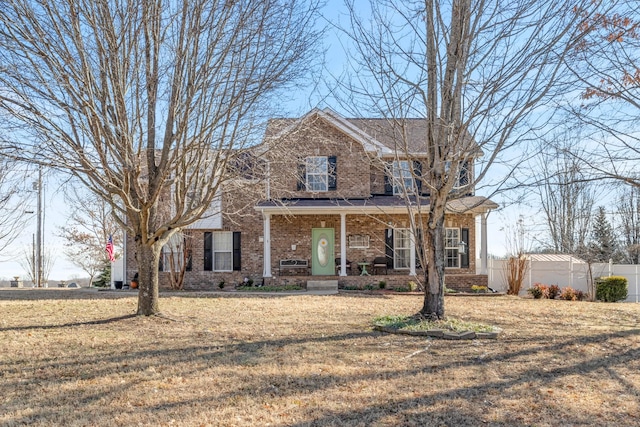 view of front of house with a porch and a front lawn