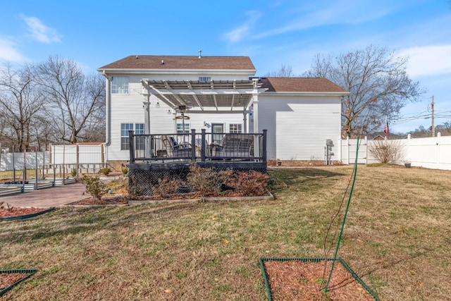 back of property with a wooden deck, a yard, and a pergola