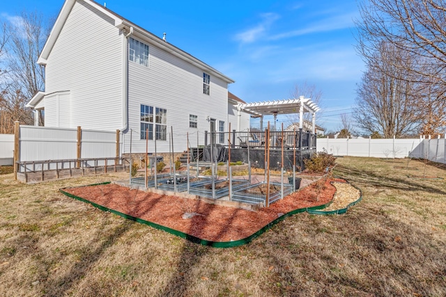 back of house with a lawn and a pergola