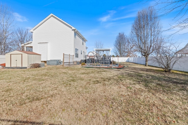 view of yard featuring a storage shed, a pergola, and central AC