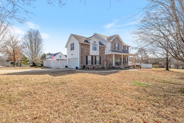 view of front of home featuring a garage, covered porch, and a front lawn