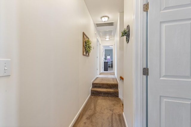 hallway featuring light colored carpet