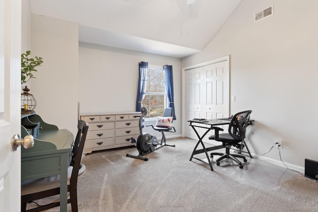 carpeted office space featuring lofted ceiling