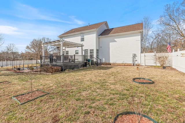 back of house with a pergola, a deck, and a lawn