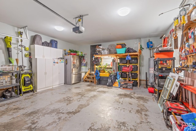 garage with a garage door opener, gas water heater, and stainless steel refrigerator with ice dispenser