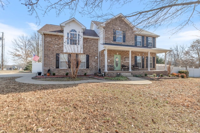 view of front of property with a front yard and covered porch