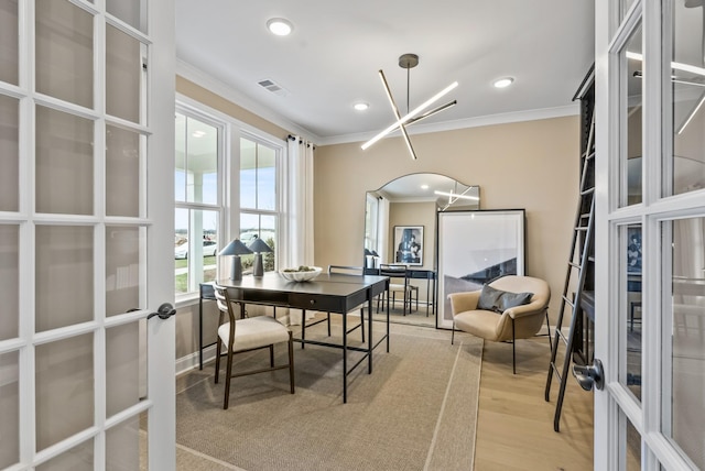 office featuring french doors, ornamental molding, an inviting chandelier, and light hardwood / wood-style flooring