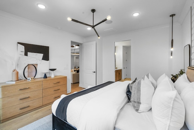 bedroom with ornamental molding, connected bathroom, and light hardwood / wood-style floors