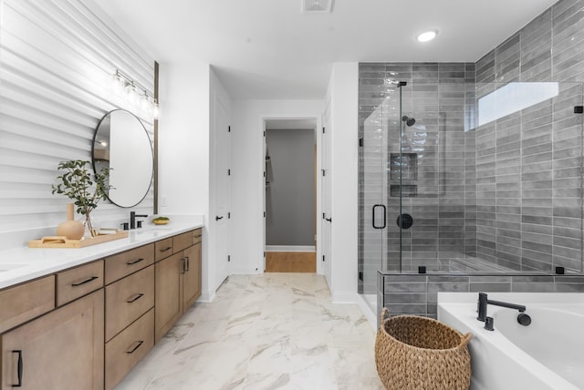 bathroom with vanity and shower with separate bathtub