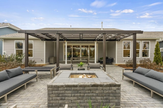 view of patio with an outdoor living space with a fire pit