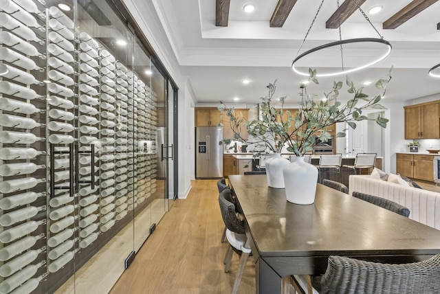 dining space with crown molding and light wood-type flooring