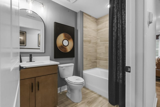 full bathroom with bathtub / shower combination, vanity, and toilet