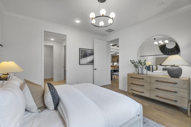 bedroom featuring ornamental molding, dark hardwood / wood-style floors, and a chandelier