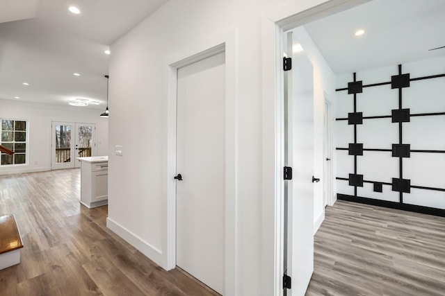 hallway with light hardwood / wood-style flooring