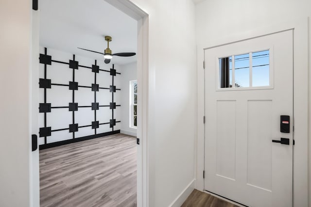 foyer featuring wood-type flooring and ceiling fan