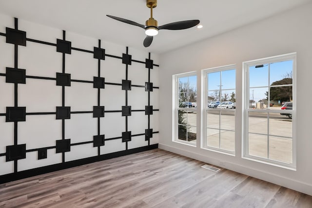 unfurnished room featuring ceiling fan and light hardwood / wood-style flooring