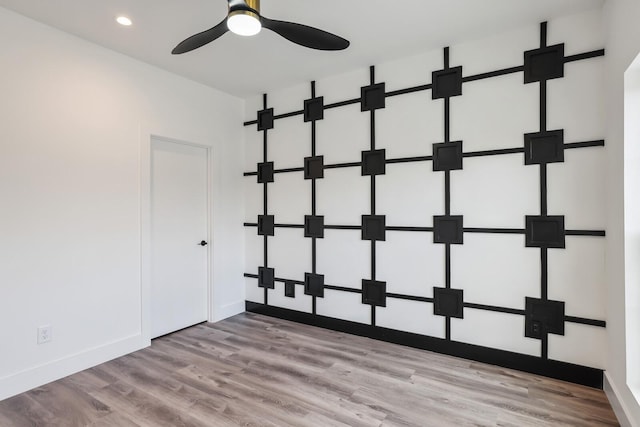 spare room featuring ceiling fan and light hardwood / wood-style floors