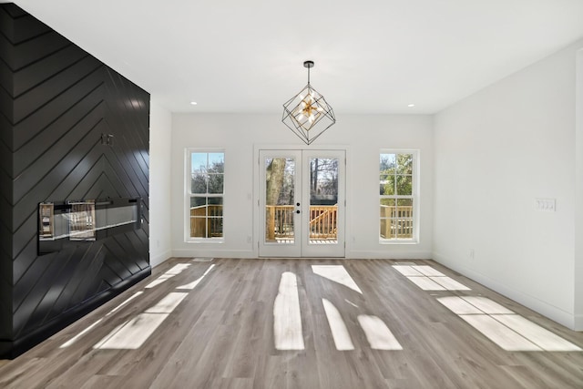 empty room featuring french doors and light wood-type flooring