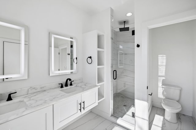 bathroom featuring vanity, an enclosed shower, and toilet