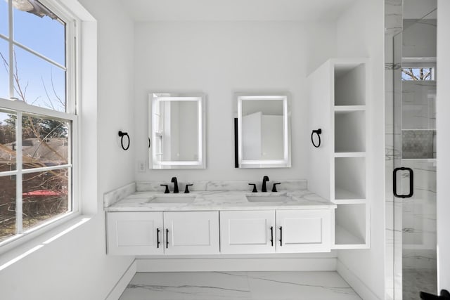 bathroom with vanity and a shower with door