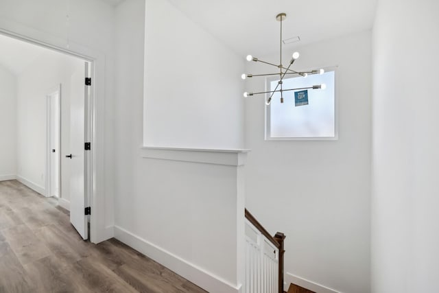 corridor with hardwood / wood-style flooring