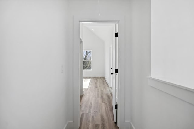 corridor with light hardwood / wood-style floors