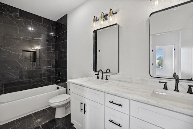 full bathroom with vanity, toilet, and tiled shower / bath combo