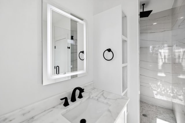 bathroom with built in shelves, vanity, and an enclosed shower