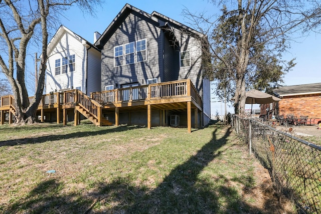 back of house with a wooden deck and a yard