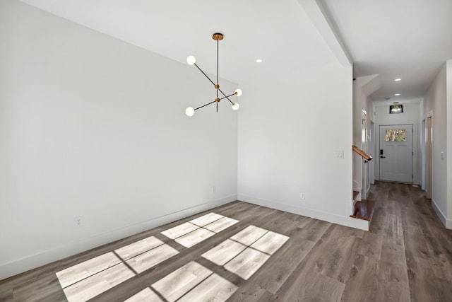 interior space featuring an inviting chandelier and light hardwood / wood-style flooring