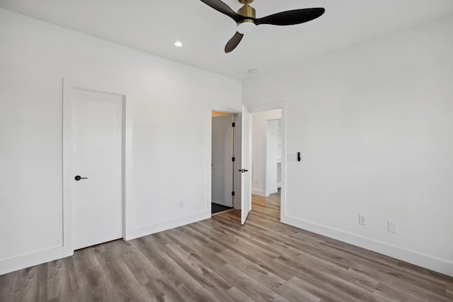 unfurnished bedroom with ceiling fan and light hardwood / wood-style flooring