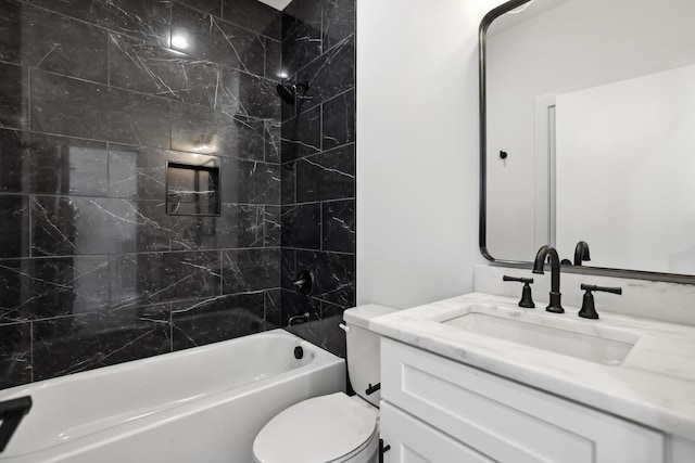 full bathroom with tiled shower / bath, vanity, and toilet