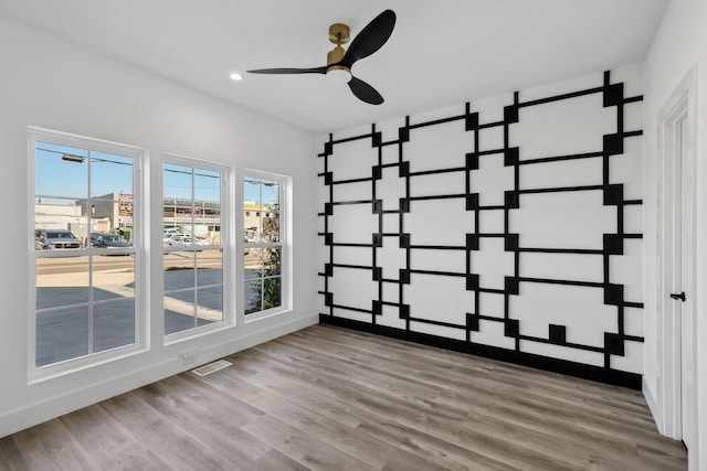 unfurnished room with ceiling fan and light wood-type flooring