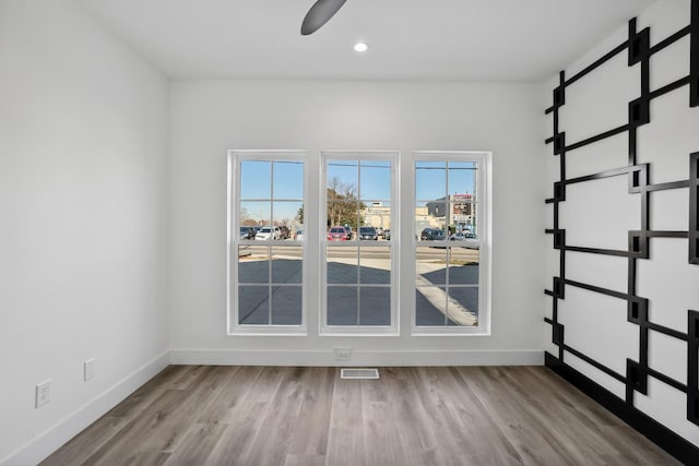 empty room featuring ceiling fan and light wood-type flooring