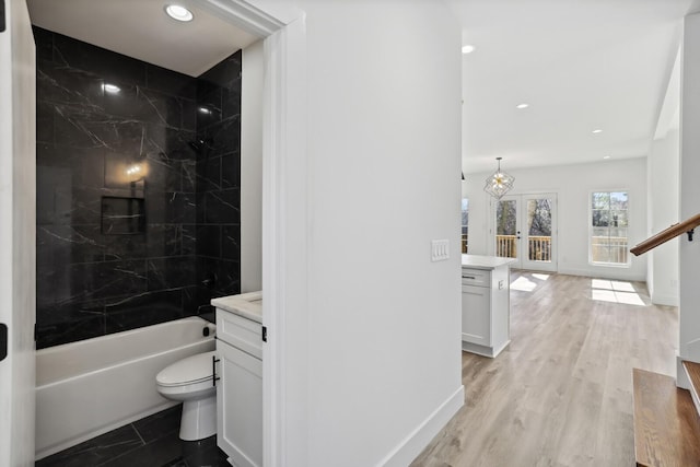 full bathroom with french doors, toilet, tub / shower combination, vanity, and hardwood / wood-style flooring