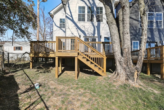 rear view of property featuring a wooden deck