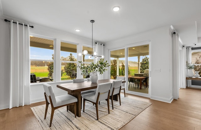 dining room with an inviting chandelier and light wood-type flooring