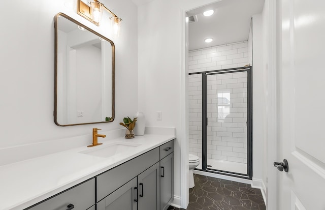 bathroom featuring tile patterned floors, toilet, an enclosed shower, and vanity