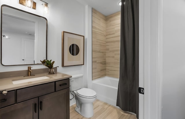 full bathroom with vanity, shower / tub combo, and toilet