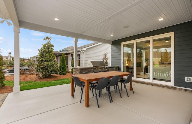 view of patio featuring an outdoor kitchen and a grill