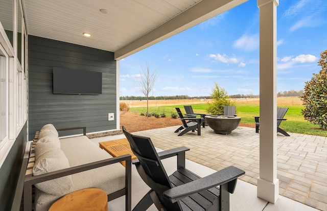 view of patio / terrace featuring a rural view and an outdoor fire pit