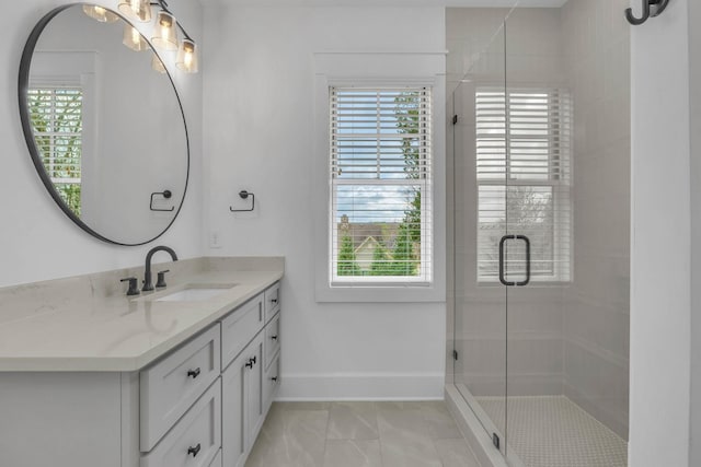 bathroom featuring a shower with door, vanity, tile patterned flooring, and a wealth of natural light