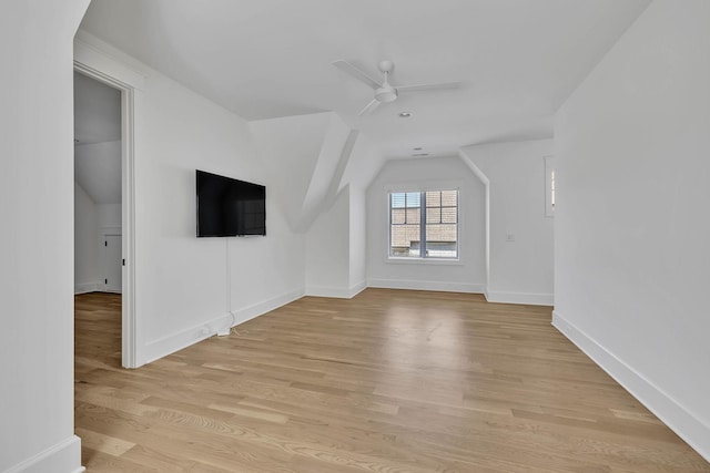 unfurnished living room with light hardwood / wood-style flooring, vaulted ceiling, and ceiling fan