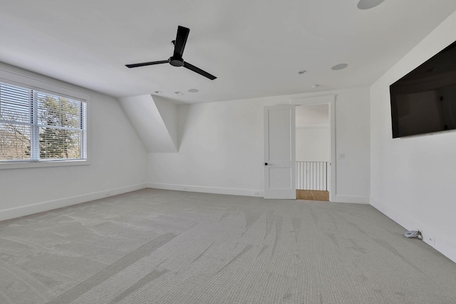 bonus room with ceiling fan, vaulted ceiling, and light carpet